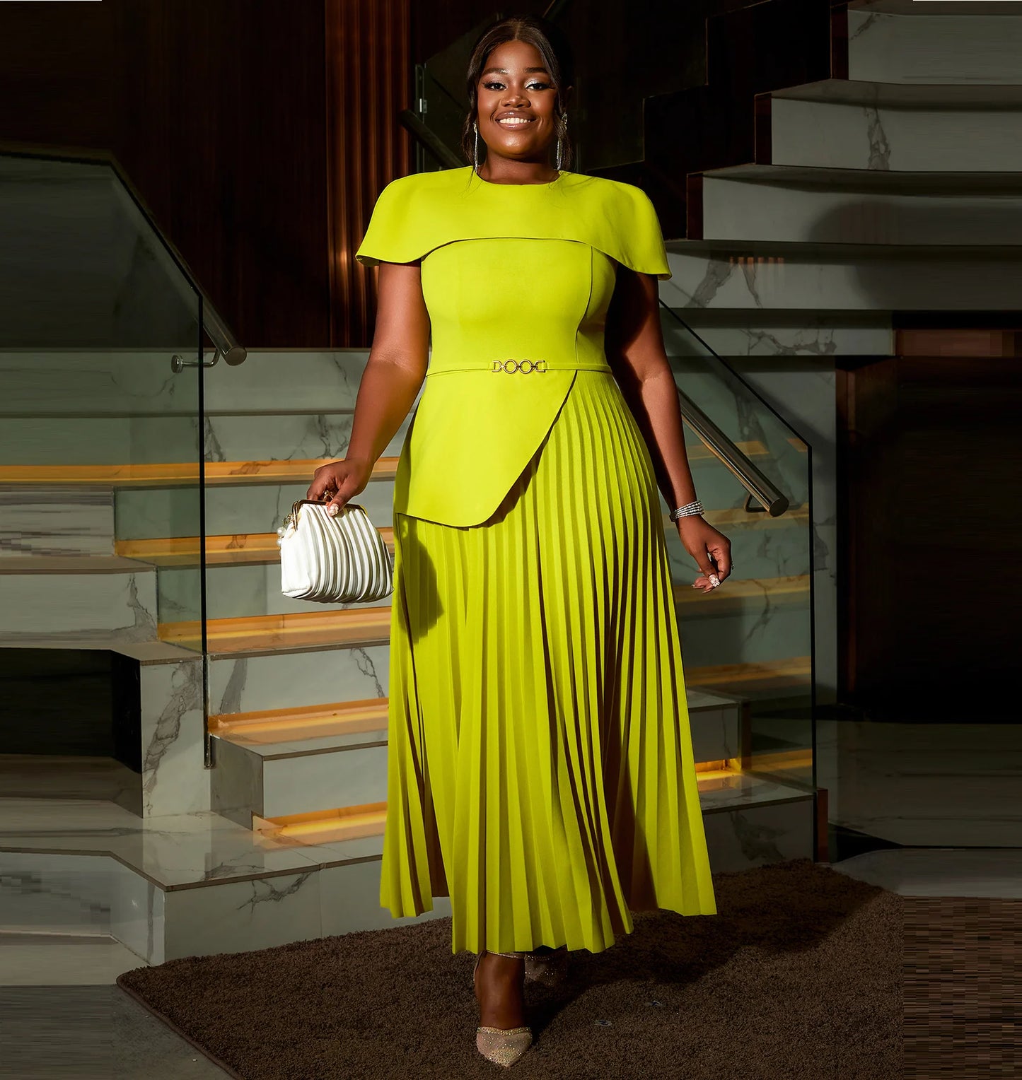 This A-Line career dress features a round collar, cape sleeves, and an asymmetric pleated design